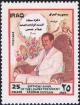 Colnect-2219-437-Saddam-in-an-arm-chair.jpg