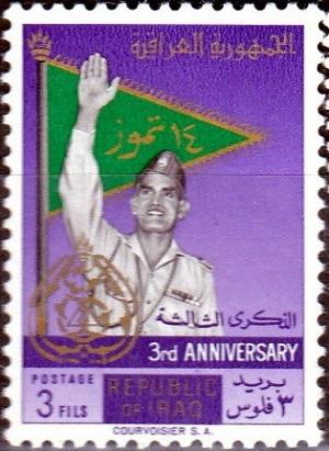 Colnect-1954-945-General-Kassem-in-front-of-flag.jpg