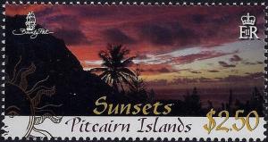 Colnect-4002-022-Deep-red-sunset-over-coast-with-trees.jpg