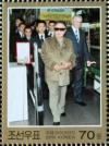 Colnect-2954-915-Kim-Jong-Il-and-delegation.jpg