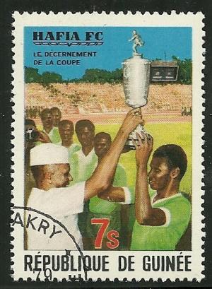 Colnect-1306-951-President-Toure-and-Player-Holding-Cup.jpg