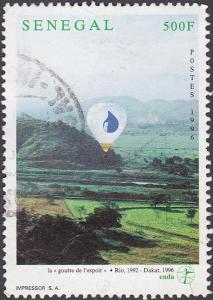 Colnect-2226-360-%E2%80%9CDrop-of-Hope%E2%80%9D-Balloon-over-Landscape.jpg