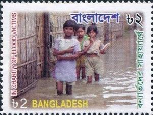 Colnect-6017-744-Three-children-standing-in-flood-water.jpg