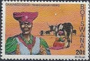 Colnect-1753-337-Herero-woman-milking-cow.jpg