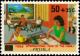 Colnect-3750-959-Family-seated-reading-studying.jpg