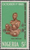 Colnect-1452-354-Seated-man-Taba-bronze.jpg