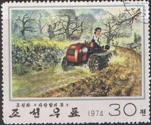 Colnect-1247-061-Farmer-with-tractor-while-plowing.jpg