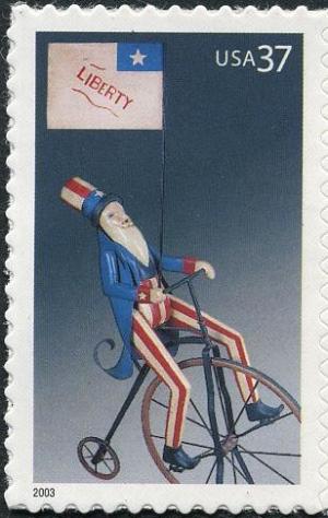 Colnect-202-095-Uncle-Sam-on-Bicycle-with-Liberty-Flag.jpg