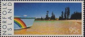 Colnect-4087-701-Beached-boat-with-rainbow-markings-and-sandy-shore.jpg